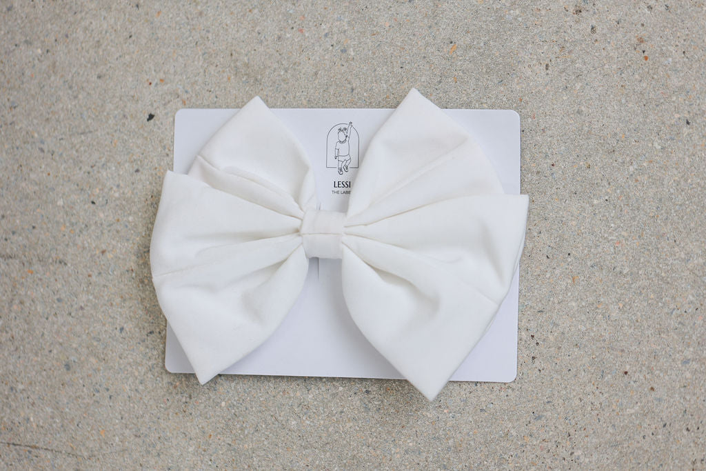Discover the Alessia Bow Bianco by Lessi The Label—a luxurious, oversized bow designed to make your little one feel like royalty. Available in four classic colors and crafted with high-quality materials. Join our family and receive 10% off your first order, plus enjoy worldwide shipping and free delivery on orders over $100!