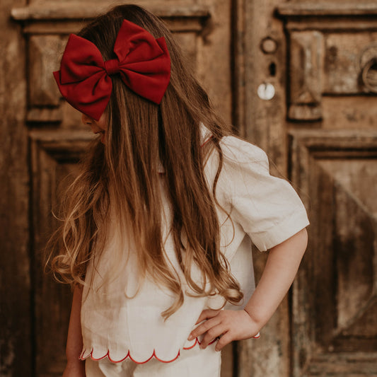 Discover the Alessia Bow in Rosso, a signature piece by Lessi the Label. Crafted for elegance, this extra-large bow makes your little one feel like royalty. Available in multiple colors to complement any style. Enjoy worldwide shipping and 10% off your first order!