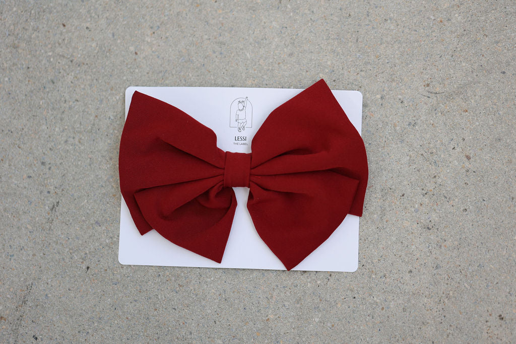 Discover the Alessia Bow in Rosso, a signature piece by Lessi the Label. Crafted for elegance, this extra-large bow makes your little one feel like royalty. Available in multiple colors to complement any style. Enjoy worldwide shipping and 10% off your first order!
